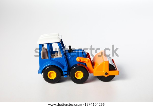 Colorful generic tractor toy isolated on\
white background. Vintage truck object for\
kids.