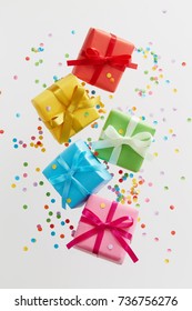 Colorful Gift Boxes With Confetti Falling Or Flying In Motion.