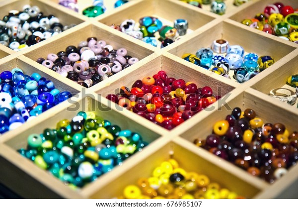 Colorful glass beads made in glassblowing workshop\
by masters. Variety of shapes and colors to make a bead necklace or\
a string of beads for\
women