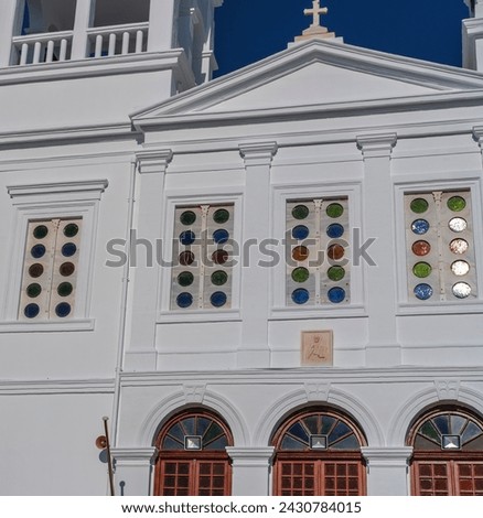 colorful glass church windows in typical greek church building , architecture details