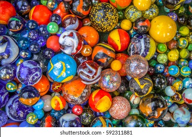 colorful Glass marbles of different sizes in a color pattern as methaphor for multicultural community diversity