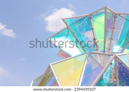 Colorful glass sculpture in the shape of a lucky bag cloudy sky background