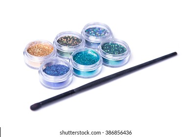 Colorful glitters and makeup brush, selective focus, isolated on white background  - Powered by Shutterstock