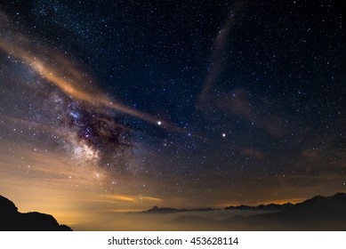 The colorful glowing core of the Milky Way and the starry sky captured at high altitude in summertime on the Italian Alps, Torino Province. Mars and Saturn glowing mid frame. - Shutterstock ID 453628114