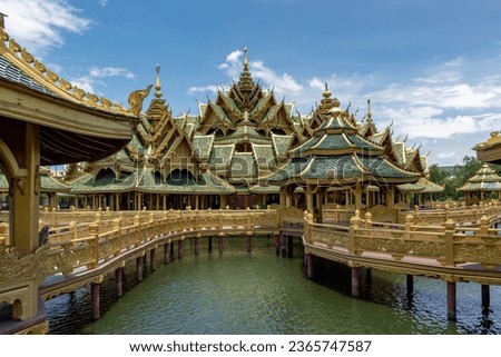 Colorful gold and emerald beautiful detail and architecture of the Pavilion Phra Arhat Pavilion of the Enlightenment on a lake in the gardens of the Ancient City Siam Bangkok Thailand