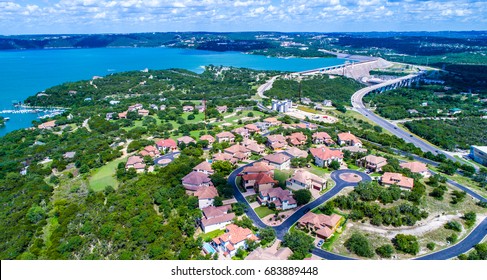 Colorful gorgeous view on top of Texas Hill country suburban mansion homes with colorful rooftops sit next to Mansfield dam near Lake Travis Austin Texas paradise view