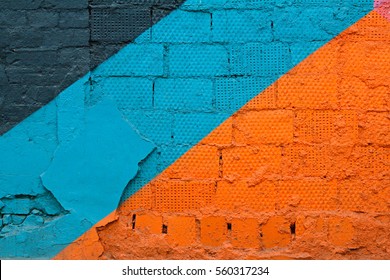 Colorful (grey, blue and orange) brick wall as background, texture - Shutterstock ID 560317234