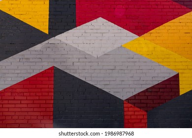 Colorful grey, red, yellow brick wall as background, texture.