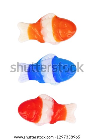 Colorful gummy candy fish in green, red, orange and yellow on a white background