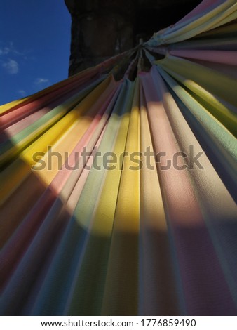 A colorful hammock lit by the summer sun