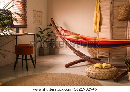Colorful hammock with pillow in modern room interior