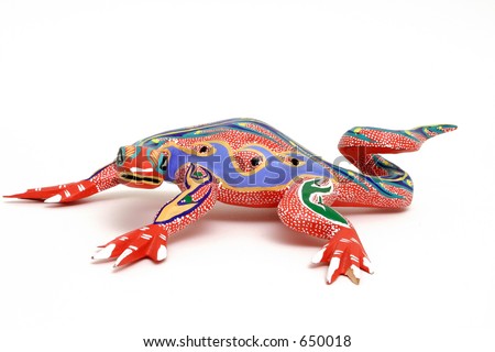 Colorful hand carved lizard. Called Alebrije.   Done by street vendors in Oaxaca, Mexico. They are safe to use since the designs have been passed from generation to generation.