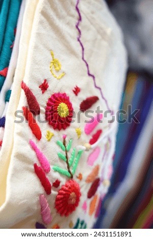 Colorful hand embroidery on a fabric, close-up with selective focus. in the old town of Antigua, Guatemala