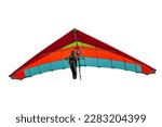 Colorful hang glider wing isolated on white. Girl pilot soar on her wing in the sky