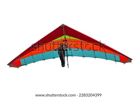 Colorful hang glider wing isolated on white. Girl pilot soar on her wing in the sky Foto d'archivio © 