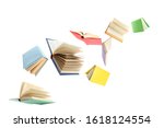 Colorful hardcover books flying on white background