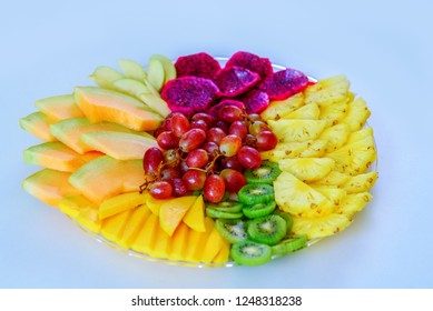 Colorful, Healthy Foods Great Idea For Good Nutrition, Vitamins Gift For Holidays. Fruit Tray Red Pitaya Dragon Fruit, Pineapple, Grapes, Mango, Melon, Kiwi On Plate On White Table.Flat Lay, Overhead.