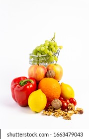 Colorful and healthy fruits and vegetables with a shopping cart against white background.