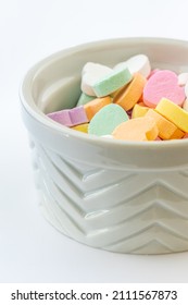 Colorful heart shaped candy on white background.