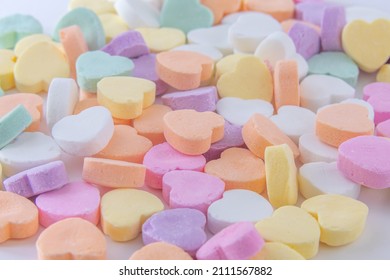 Colorful heart shaped candy on white background.