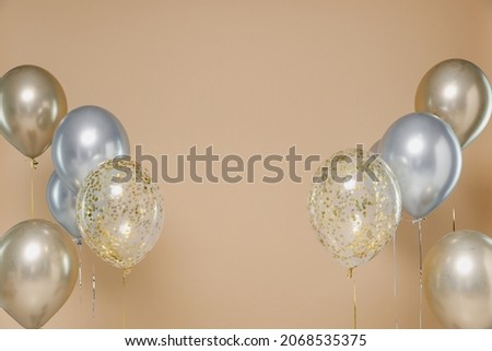Colorful helium air balloons isolated on pastel bright trending plain pastel light beige background studio. Birthday fun decoration celebrate holiday new year 8 party event concept Mock up design area
