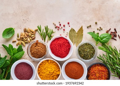 Colorful Herbs And Spices For Cooking: Turmeric, Dill, Paprika, Cinnamon, Saffron, Basil And Rosemary. Indian Spices. On Light Brown Stone Background. Top View.