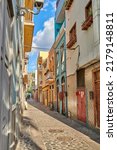 Colorful historic buildings in vibrant city of Santa Cruz de La Palma with cobblestone alleyway on a sunny day. Bright residential houses in a popular village of a travel and tourism destination