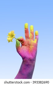 Colorful Holi Painted Hand Holding Yellow Flower