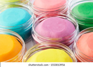 Colorful homemade play dough in transparent plastic containers. - Powered by Shutterstock