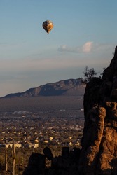 A Colorful Hot Air Balloon In The Sky Above The Sonoran Desert. Early Morning Adventure In A Balloon Floating Past Mountains And Saguaro Cacti Near Tucson, Arizona In Pima County, USA.