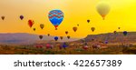 Colorful Hot Air balloons flying over Mountains landscape silhouette with sunrise Cappadocia, Turkey
