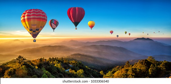 Colorful hot air balloons flying over mountain at Dot Inthanon in Chiang Mai, Thailand. - Shutterstock ID 1033306540