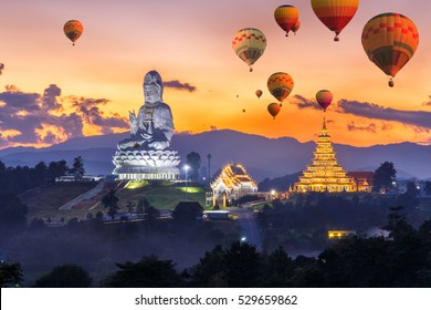 Colorful hot air balloons flying over Wat Huay Pla Kang, Chinese temple in Chiang Rai Province, Thailand
