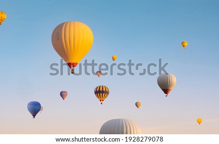 Colorful hot air balloons flying in clear blue sky