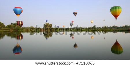 Colorful Hot Air Balloons launching over a lake in Ayuthaya, Thailand