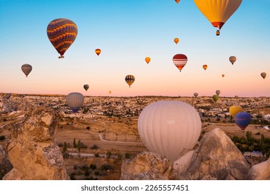 Colorful hot air balloons taking part in festival in sunset sky - Shutterstock ID 2265557451