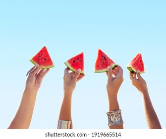 Colorful hot summer holidays. Close up slices of watermelon in hands. Friends are holding slice of watermelon - Powered by Shutterstock