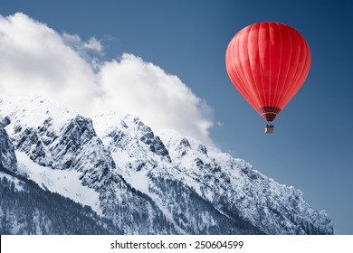 Colorful hot-air balloon flying over snowcapped mountain - Powered by Shutterstock