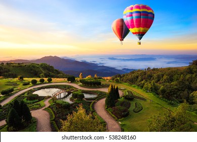 Colorful hot-air balloons flying over the doi Inthanon national park with sunrise and morning mist at Chiang mai, Thailand.