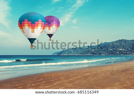 Colorful hot-air balloons flying over the sea