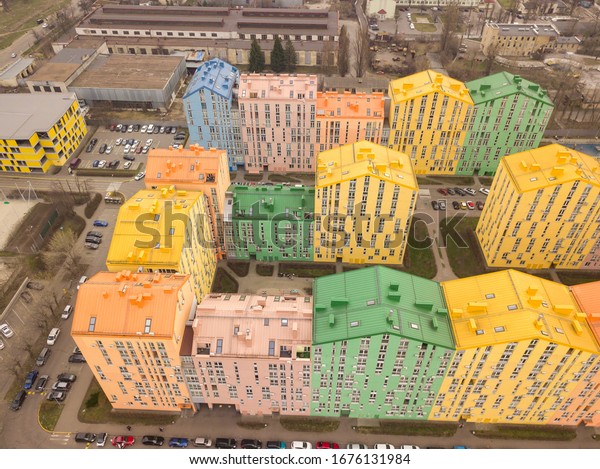 Colorful houses in Comfort Town
district in Kyiv at cloudy weather. Aerial panoramic drone
photo,