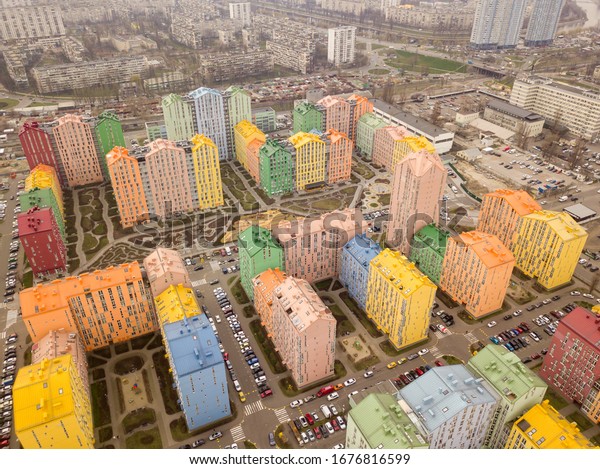 Colorful houses in Comfort Town
district in Kyiv at cloudy weather. Aerial panoramic drone
photo,