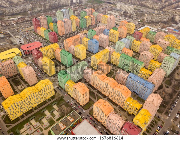 Colorful houses in Comfort Town\
district in Kyiv at cloudy weather. Aerial panoramic drone\
photo,