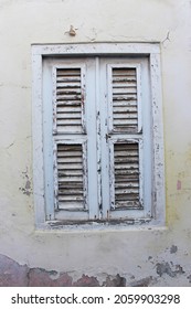 Colorful Houses Of The Island Curaçao With Broken Walls, Windows And Doors Covered With Plants