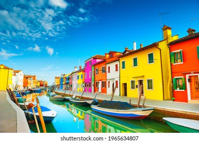 Colorful houses on the canal in Burano island, Venice, Italy. Famous travel destination.