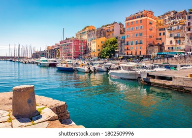 Colorful houses on the shore of Bastia port. Bright morning view of Corsica island, France, Europe. Magnificent Mediterranean seascape with yacht. Traveling concept background.