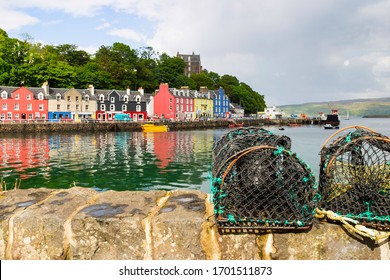 Colorful houses at the port of Tobermory in Scotland and lobster traps