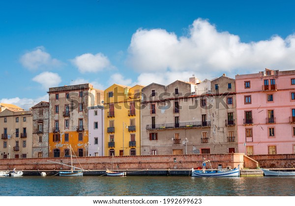 Colorful houses with ruined painting in\
front of the river. Houses with colorful paints.\
