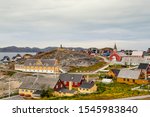 Colorful houses with the school Det gamle Sygehus, the cathedral and the statue of Hans Egede in the background, Nuuk, Greenland.