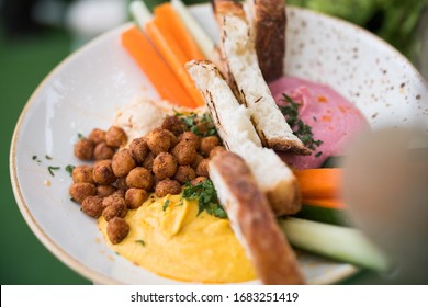 Colorful Hummus And Chickpea Vegan Whole Foods Plant Based Meal With Spices And Grilled Bread